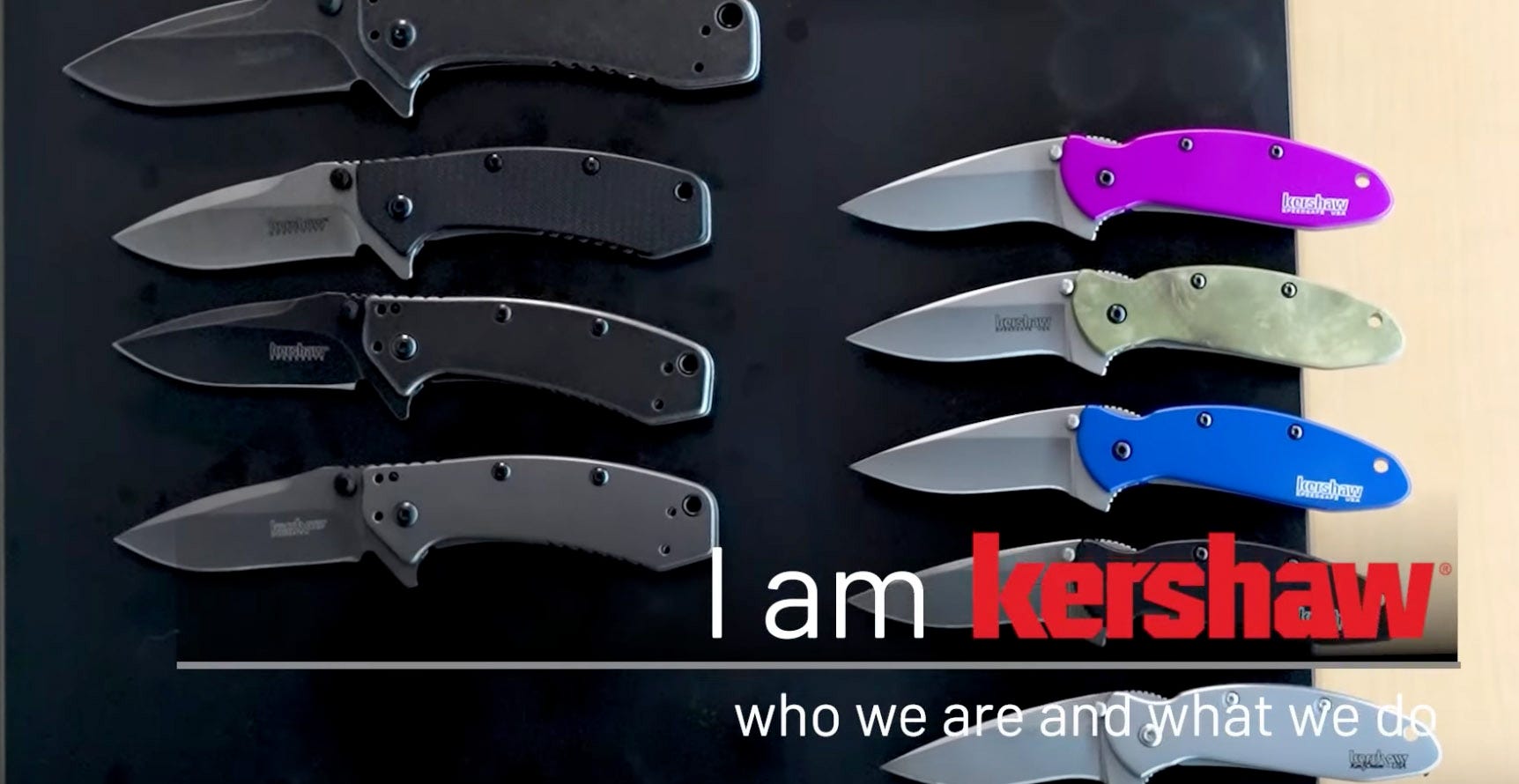 Nine Kershaw knives are displayed on a knife mat. Four knives with gray and black finishes in an open position are on the left and five Kershaw Scallion knives are on the right. Click to play video.