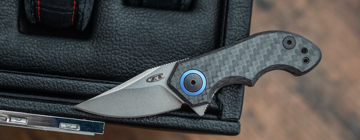 Small ZT knife with carbon fiber handles in car